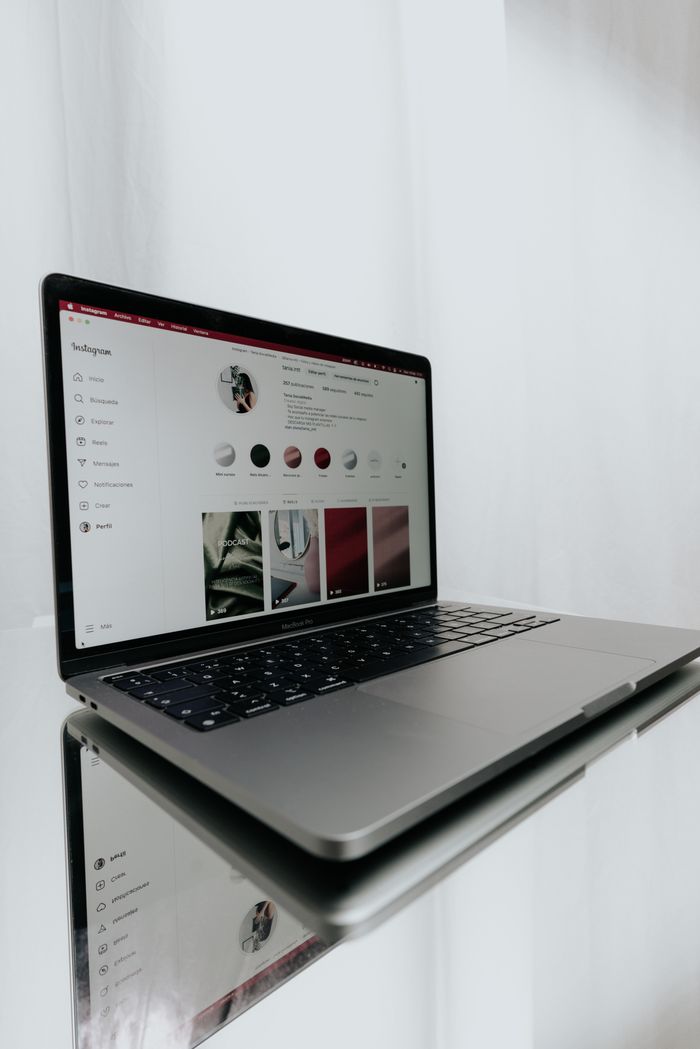 about-us-01 Sleek laptop displaying an Instagram profile, showcasing modern technology and online connectivity.